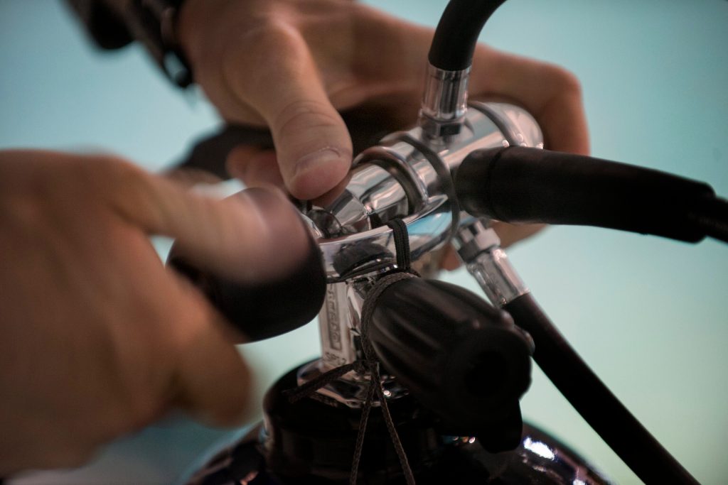 An Airman from the 38th Rescue Squadron ensures the connection between the air tank and the air hose is snug, Jan. 20, 2016, at Moody Air Force Base, Ga. Airmen must secure their equipment before entering the pool. (U.S. Air Force photo by Airman Daniel Snider/released)