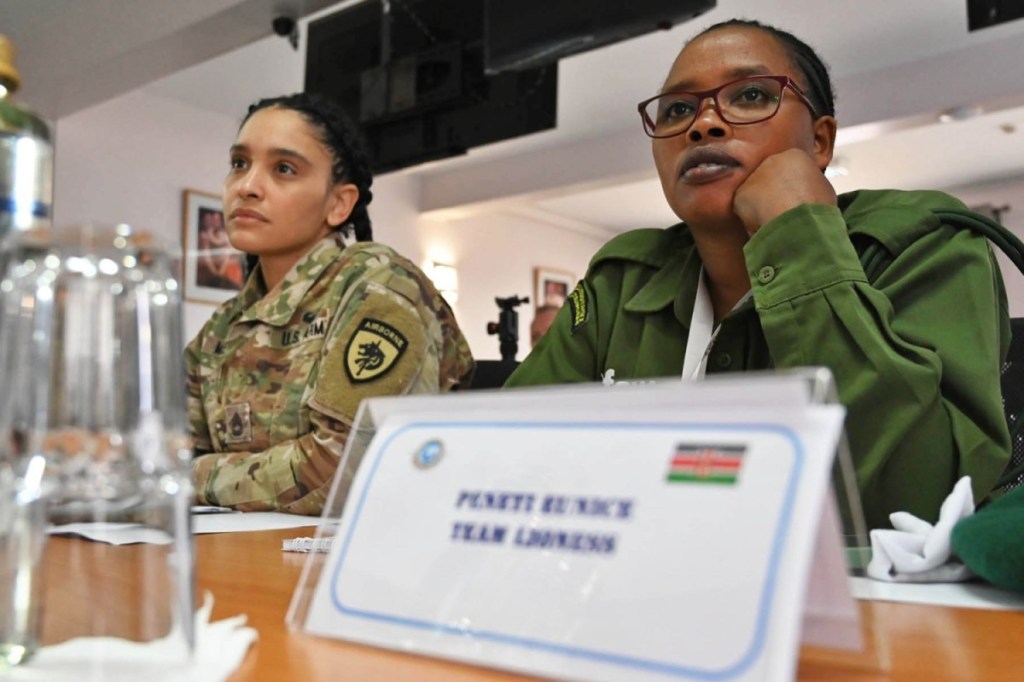 Eunice Peneti, a wildlife ranger with International Fund for Animal Welfare, and Sgt. First Class Sierra Melendez, the joint public affairs noncommissioned officer in charge with U.S. Special Operations Command Africa (SOCAF) listens to opening remarks for the Women in Security Conference supported by SOCAF in Nairobi, Kenya, March 21, 2023