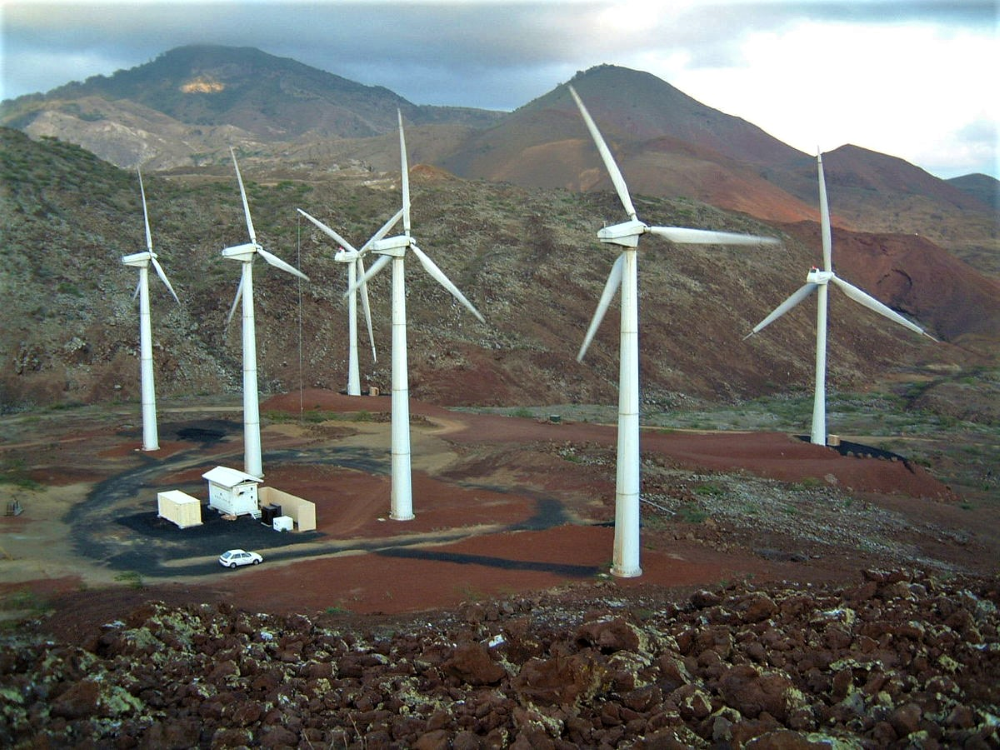 Wind farm with energy storage containers on site.