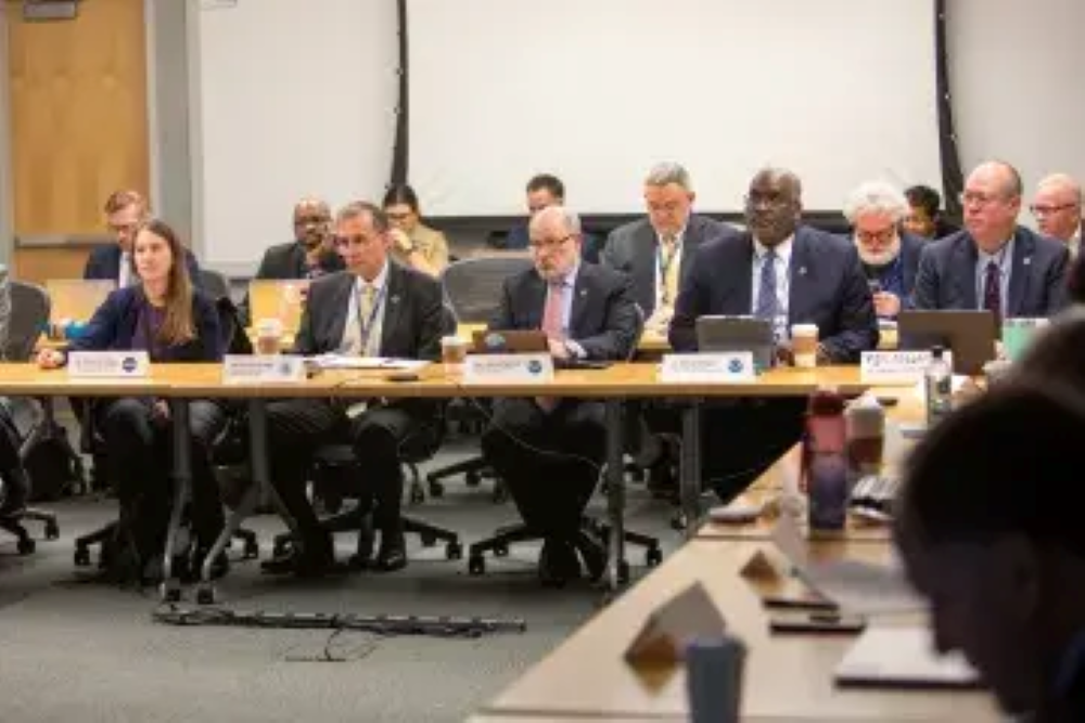 S&T Under Secretary Dr. Dimitri Kusnezov and several colleagues sitting at a conference.