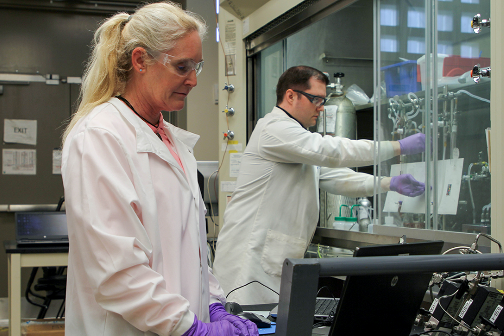 Two scientists performing an experiment in a laboratory.