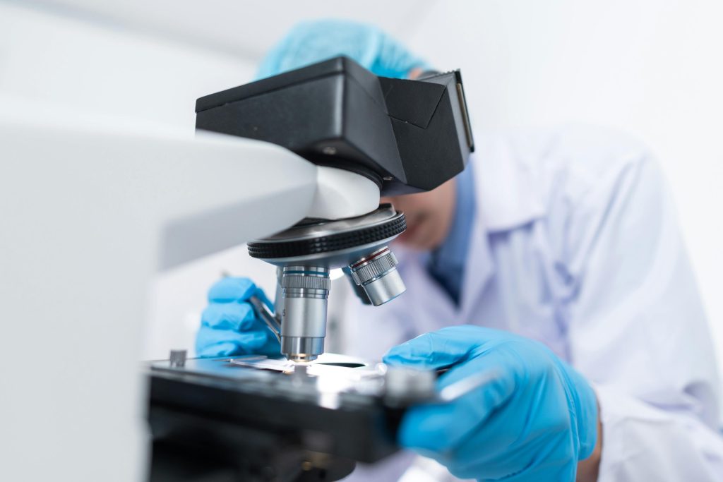 scientist using a microscope