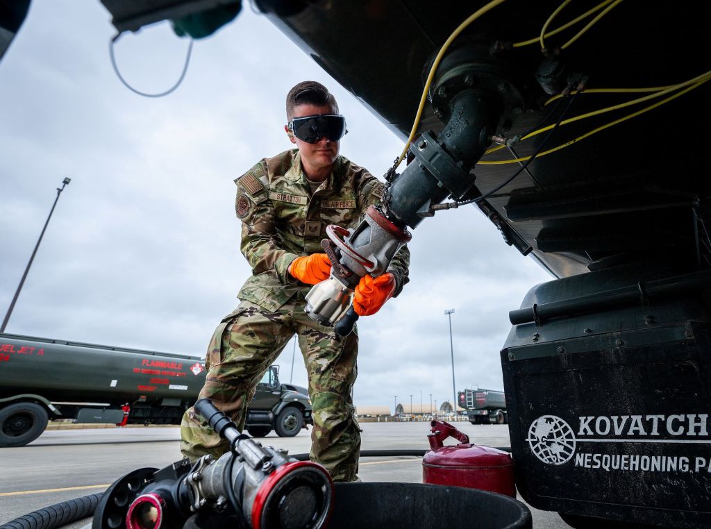 Tech. Sgt. Collin Stratton, 96th Logistics Readiness Squadron, secures his single-point nozzle adapter to an R-11 fuel truck Nov. 6, 2024 at Eglin Air Force Base, Florida. The SN adapter, an innovation created by Stratton, makes fuel sampling easier and safer by reducing the steps required to gain the sample. Fuel samples are taken to ensure aircraft fuel is free of water and other contaminants. (U.S. Air Force photo by Samuel King.)