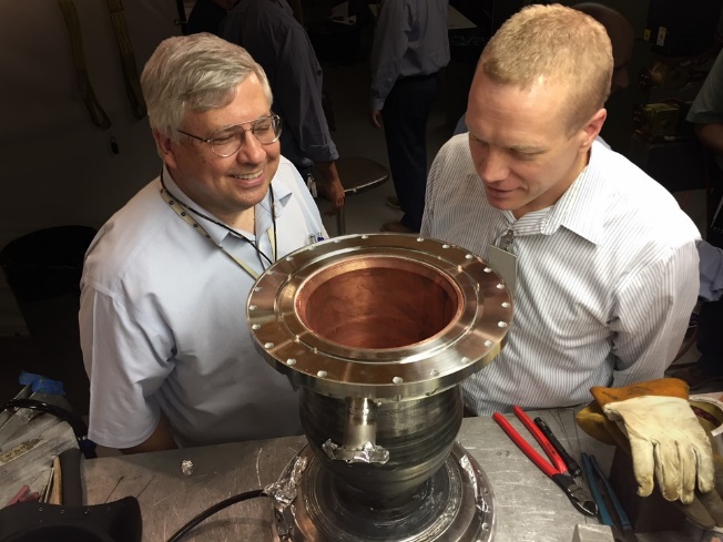 Figure 2. NASA Materials Engineers Dave Ellis and Chris Protz Inspect the First Additive-Manufactured GRCop Combustion Chamber (Source: Kilkenny [11]).