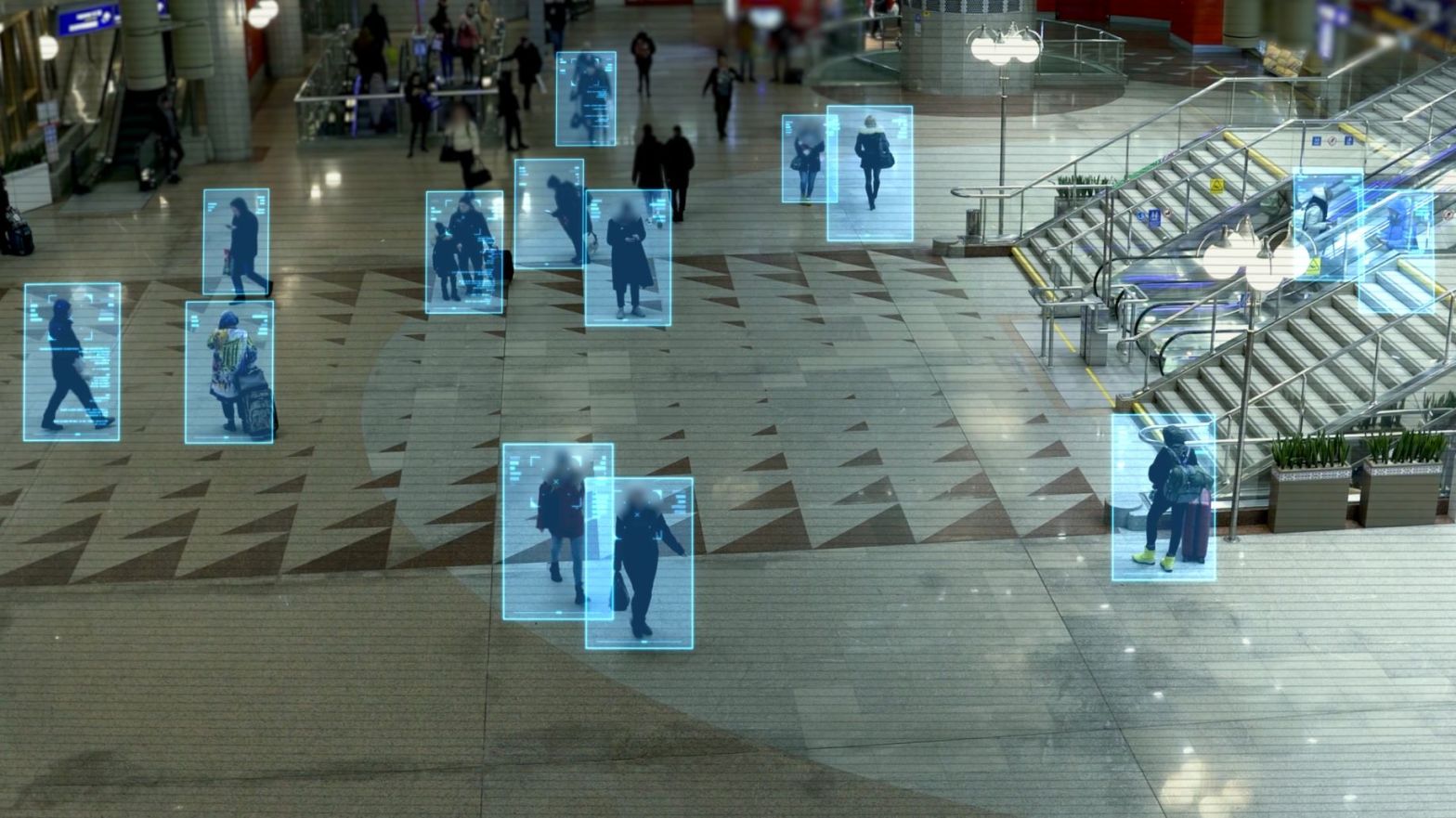 people walking in a public area with digital blue boxes highlighting them