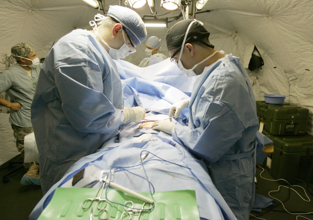 Surgeons operate on a person.