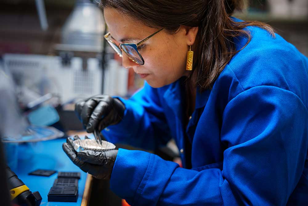LOW-POWER DEVICES — Sandia microelectronics engineer Mieko Hirabayashi transfers microelectronic devices into storage containers. (Photo by Craig Fritz)