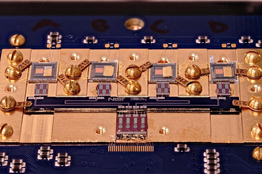Close-up of a superconducting sensor board containing multiple transition edge sensors (top row of squares), which detect energy released by individual radioactive decay events. Credit: M. Carlson/NIST