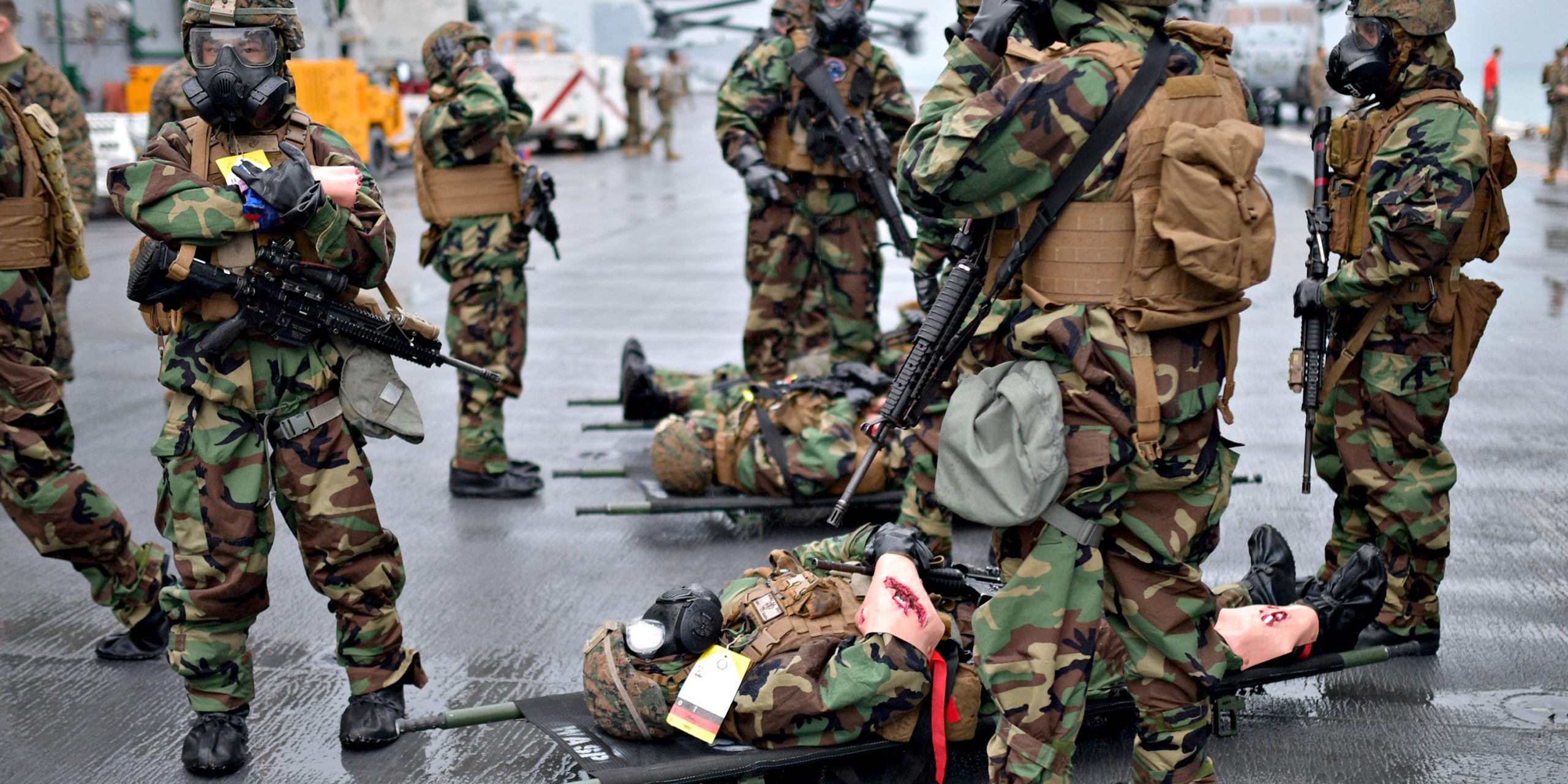 U.S. Sailors and Marines assigned to the 31st Marine Expeditionary Unit (MEU) take part in a chemical, biological, radiological, and nuclear (CBRN) mass casualty drill on the flight deck of the amphibious assault ship USS Wasp (LHD 1), East China Sea, on October 22, 2018. Wasp, flagship of Wasp Amphibious Ready Group, with embarked 31st MEU, is operating in the Indo-Pacific region to enhance interoperability with partners and serve as a ready-response force for any type of contingency (U.S. Navy photo by Mass Communication Specialist 1st Class Daniel Barker).