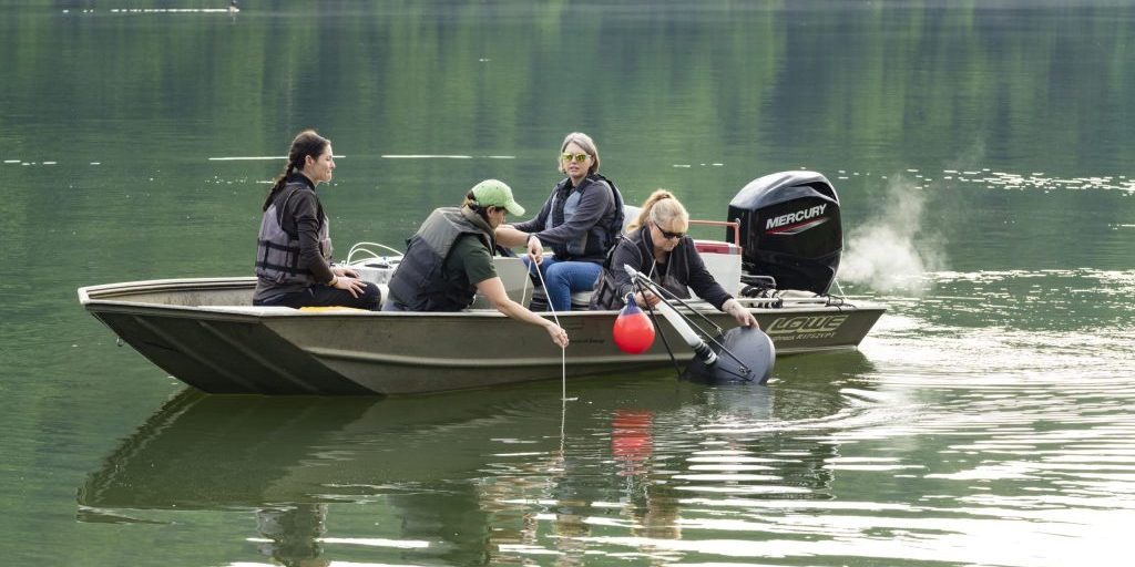 ORNL researchers deploy a gas trap to measure ebullitive (bubbling) emissions of methane at the Melton Dam in East Tennessee. The trap is deployed for ~24 hours to allow gas to accumulate in the trap (credit:  Carlos Jones/ORNL, U.S. Dept. of Energy).