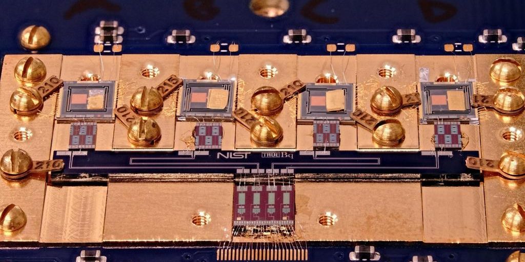 Close-up of a superconducting sensor board containing multiple transition edge sensors (top row of squares), which detect energy released by individual radioactive decay events. Credit: M. Carlson/NIST