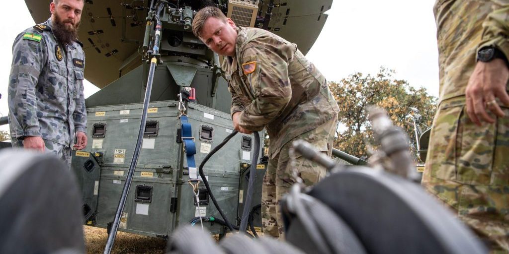 U.S. Space Force Tech. Sgt. Alexander Hamilton (center), the lead range technician for 25th Space Range Squadron, in support of U.S. Space Command, sets up a communications satellite with his Australian counterparts July 15 at Lavarack Barracks in Queensland, Australia, during Exercise Talisman Sabre 21. TS21 is Australia’s largest military exercise with the US and is a demonstration of the strong alliance underpinned by deep levels of cooperation and trust built over decades of operating and training together (U.S. Navy photo by Mass Communication Specialist 1st Class Jen S. Martinez/released).