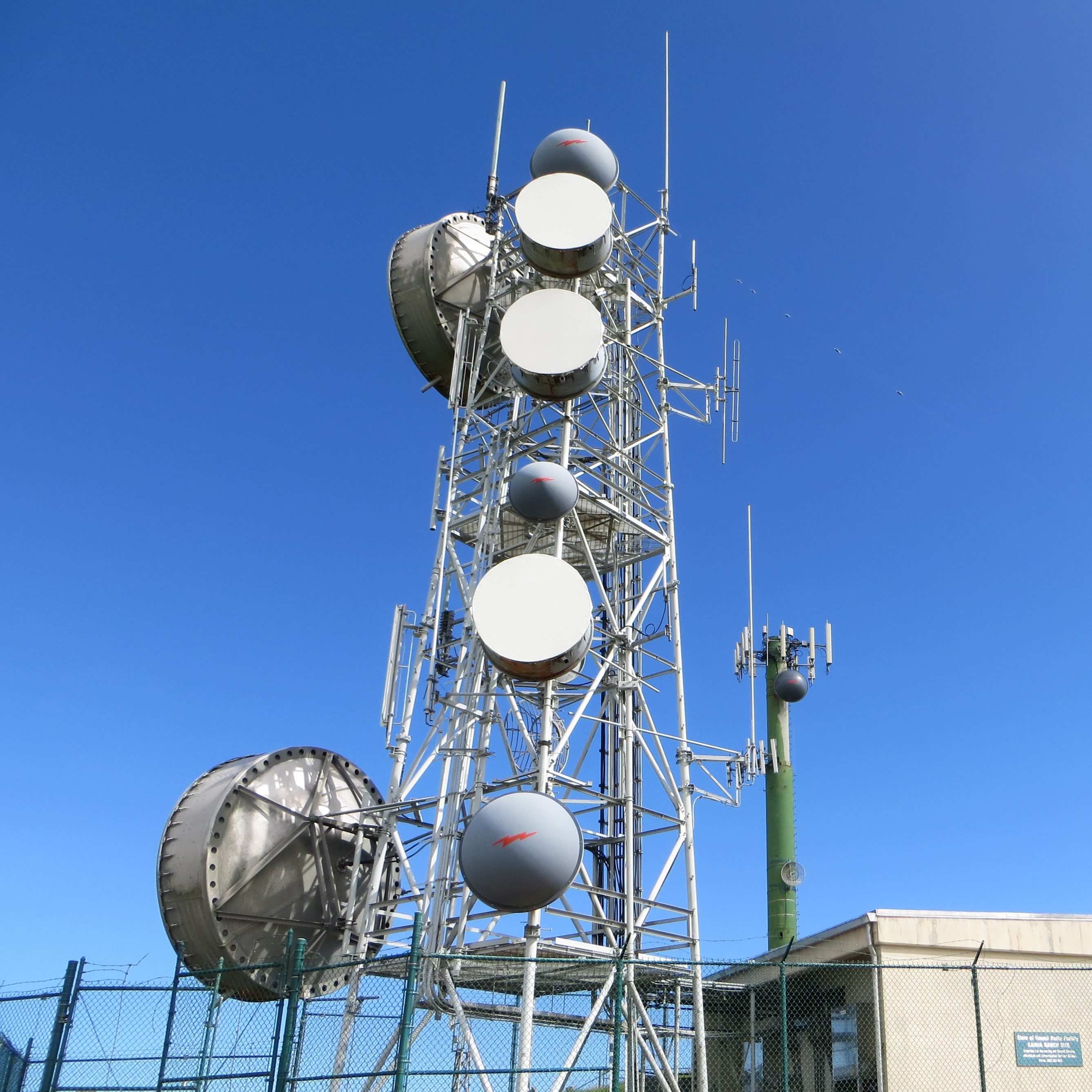 The Kahua ranch radio site, located on the island of Hawaii, is one of the tower sites that comprise the Anuenue digital microwave system throughout the Hawaiian Islands. Anuenue is a collaborative partnership with the U.S. Coast Guard and the state of Hawaii that replaced the aging analog microwave with a digital data transport system to support official emergency communications requirements for state and federal agencies. (U.S. Coast Guard courtesy photo/Released)