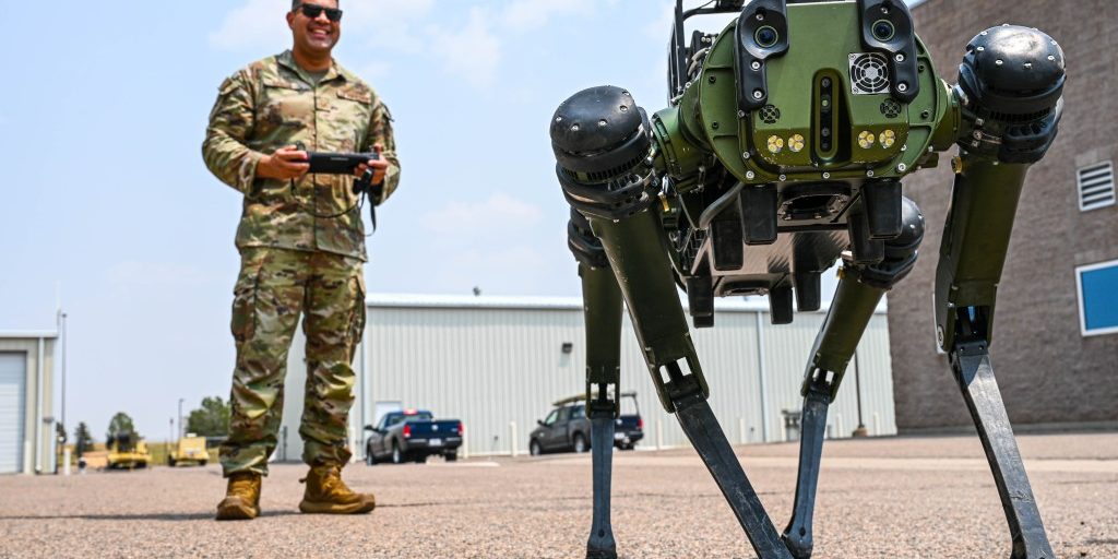 soldier operating the Chemical, Biological, Radiological, and Nuclear Quadrupedal Unmanned Ground Vehicle, named CHAPPIE