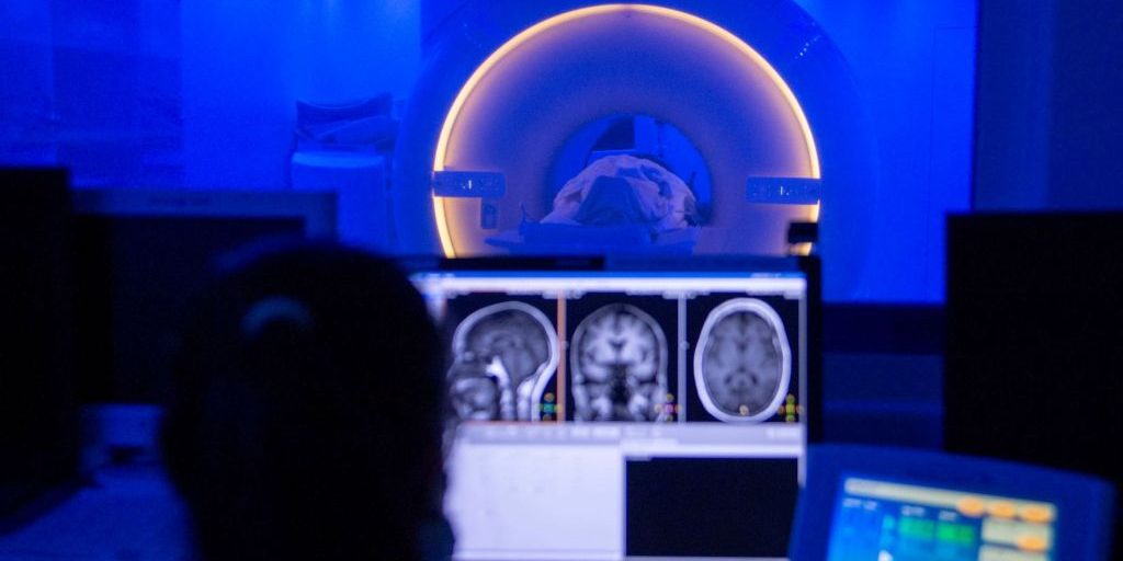 200803-N-LW757-1020 SAN DIEGO (Aug. 3, 2020) Lorie Falaminiano, an MRI technologist assigned to Naval Medical Center San Diego (NMCSD), conducts an MRI scan of a patient's brain at the hospital Aug. 3.