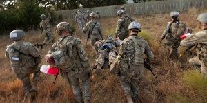 U.S. Soldiers assigned to the U.S. Army Medical Center of Excellence engage in prolonged casualty care techniques during a combat medic field training exercise at Joint Base San Antonio-Camp Bullis, Texas, Oct. 21, 2024. The course expanded upon Army medic base level skills, including how to keep casualties of combat operations alive for 12-24 hours after engagement. The soldiers neutralized threats on patrol and transported the wounded to the nearest battalion aid station to continue emergency care. Upon completion of the FTX, the students graduated from the combat medic course, obtaining the occupational specialty code of 68W. (U.S. Air Force photo by Kathryn R.C. Reaves)