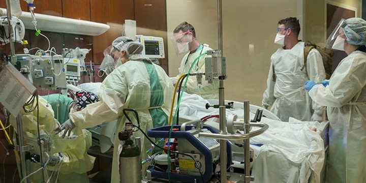 Trauma personnel receive an extracorporeal membrane oxygenation or ECMO patient into the Emergency Department at Brooke Army Medical Center, Joint Base San Antonio-Fort Sam Houston, Texas, January 24, 2022. MHS GENESIS new functionalities support BAMC’s Level I Trauma Center (photo:  Corey Toye, Brooke Army Medical Center).