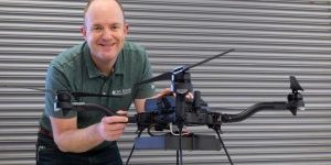 Hines stands beside the Arktis, a drone-based radiation detection system. Credit: ORNL, U.S. Dept. of Energy