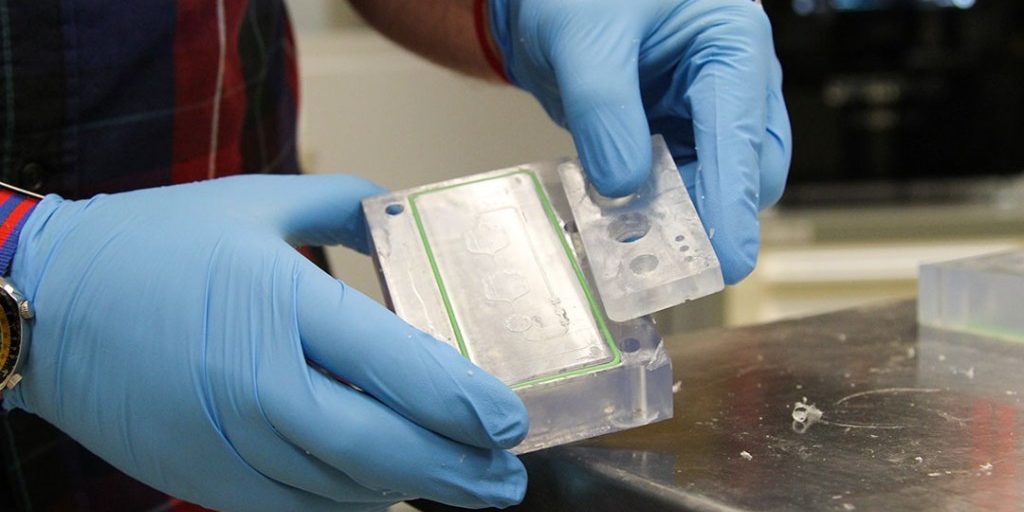 Makerspace program lead Bradley Ruprecht displays an organ-on-a-chip mold created from 3D printers in the Advanced Design and Manufacturing Rapid Technologies Lab at the U.S. Army Combat Capabilities Development Command Chemical Biological Center (U.S. Army photo by Ellie White).