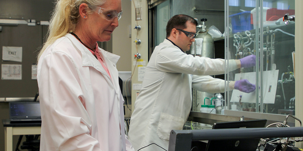 Two scientists performing an experiment in a laboratory.