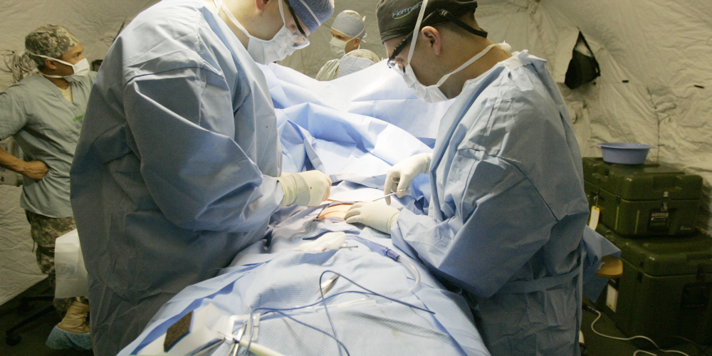 Surgeons operate on a person.