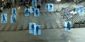 people walking in a public area with digital blue boxes highlighting them