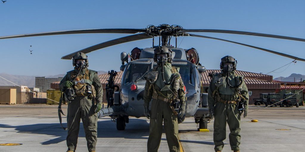 Airmen assigned to the 88th Test and Evaluation Squadron pose for a photo in full chemical, biological, radiological, and nuclear flight gear during a developmental test at Nellis Air Force Base, Nevada, April 21, 2021. The Airmen participated in on-going testing of the new Uniform Integrated Protective Ensemble (UIPE) Air two-piece system (U.S. Air Force photo by Senior Airman Dwane R. Young).