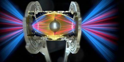 False-color illustration of laser beams irradiating a NIF hohlraum shaped like a rugby ball and holding an aluminum fuel capsule, one of several new target designs being explored on the NIF system. The laser beams enter the hohlraum through laser entrance holes and strike the inside of the hohlraum to generate x rays. The laser beams are arranged in two cones—an inner cone that is pointed toward the waist of the hohlraum and an outer cone that is pointed near the ends. Ignition is achieved when a self-sustaining fusion reaction produces more energy than the energy absorbed by the target capsule. Credit: Jacob Long, LLNL