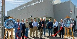 THE CUT — Sandia Associate Labs Directors Jeff Heath, far left, and Steve Girrens, far right, along with technologist and engineers gather for the Light Initiated High Explosives ribbon-cutting on March 11. (Photo by Bret Latter)