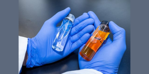 The left clear sample is the world’s first 100% bio-based acetonitrile that meets oligonucleotide-grade specifications. On the right is aviation fuel blendstock. Photo by Gregory Cooper, NREL
