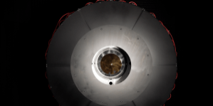 In the optical power beaming receiver designed for PRAD, the laser enters the center aperture, strikes a parabolic mirror, and reflects onto dozens of photovoltaic cells arranged around the inside of the device which convert the energy back to usable power. Source: DARPA