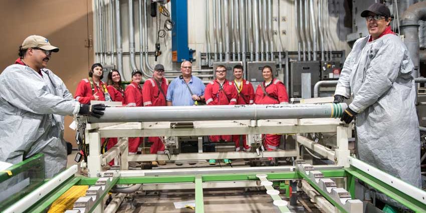 Operators pose with the last GB nerve agent rocket as it is loaded for destruction at the Blue Grass Chemical Agent-Destruction Pilot Plant on July 7, 2023. The destruction of this munition marked the completion of destruction of the U.S. chemical weapons stockpile (U.S. Army).